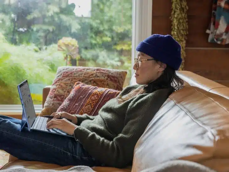 a person sitting at a table using a laptop